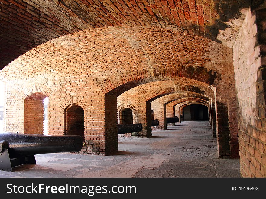 Old immobilized cannons inside brick arches of a Fort in Key West Florida. Zachary Taylor State Park. Gun rooms. Old immobilized cannons inside brick arches of a Fort in Key West Florida. Zachary Taylor State Park. Gun rooms.