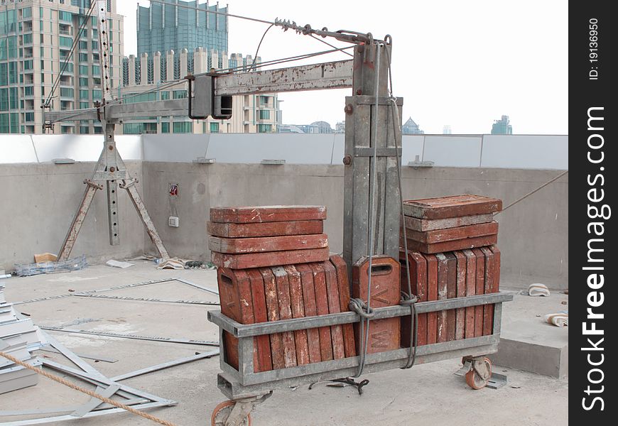 Counter weight of a construction crane on top of a high-rise building. Counter weight of a construction crane on top of a high-rise building