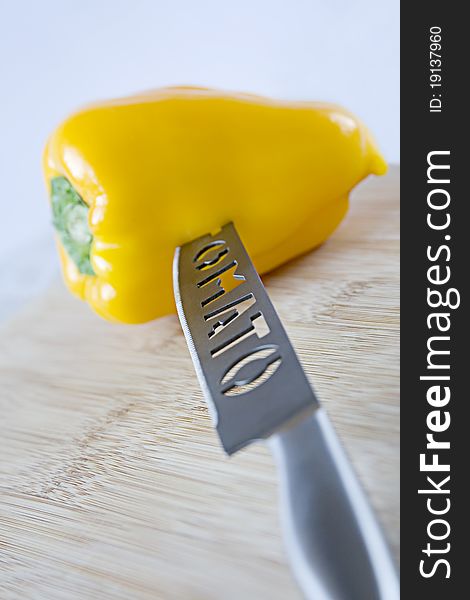 Sweet yellow pepper with a knife