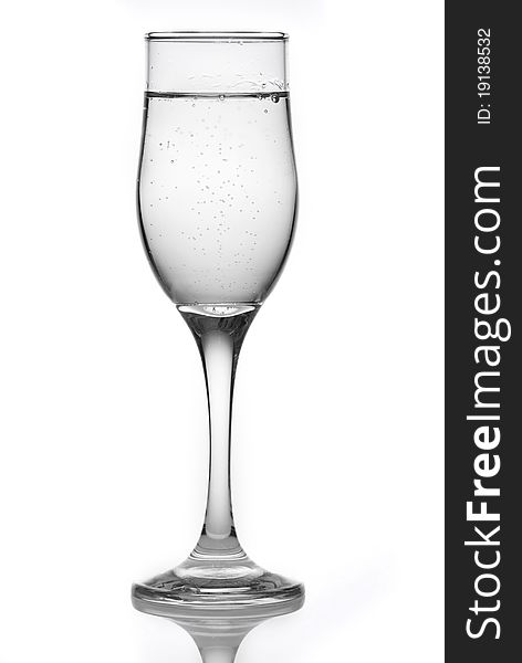 Glass with mineral water isolated on a white background