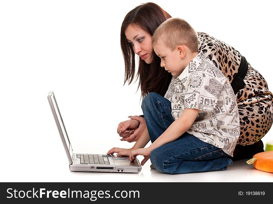 Mother and son playing with laptop isolated on white background