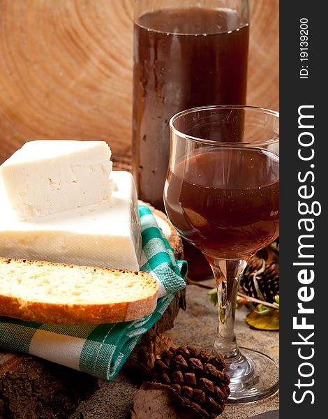 White cheese and rose wine on a rustic setting