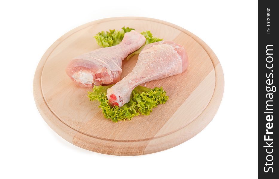 Fresh raw chicken legs on wooden board, clipping path included