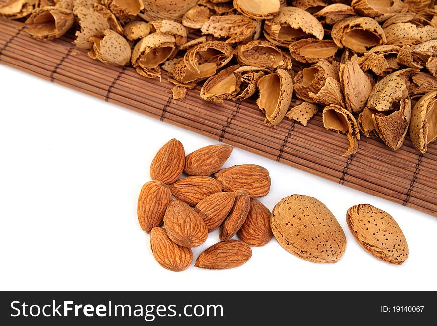 Almond nuts and kernels with hulls on white background. Almond nuts and kernels with hulls on white background