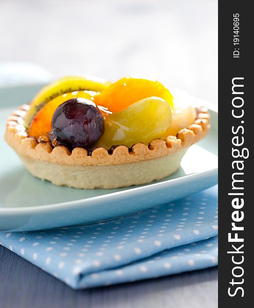 Fresh fruit cake with wine grapes on plate