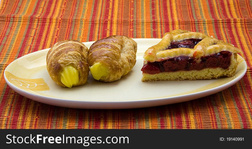 Cake with jam and pastries with cream. Cake with jam and pastries with cream