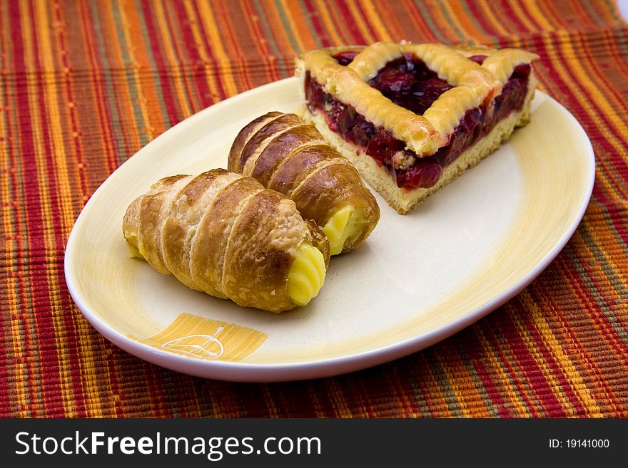 Cake with jam and pastries with cream. Cake with jam and pastries with cream