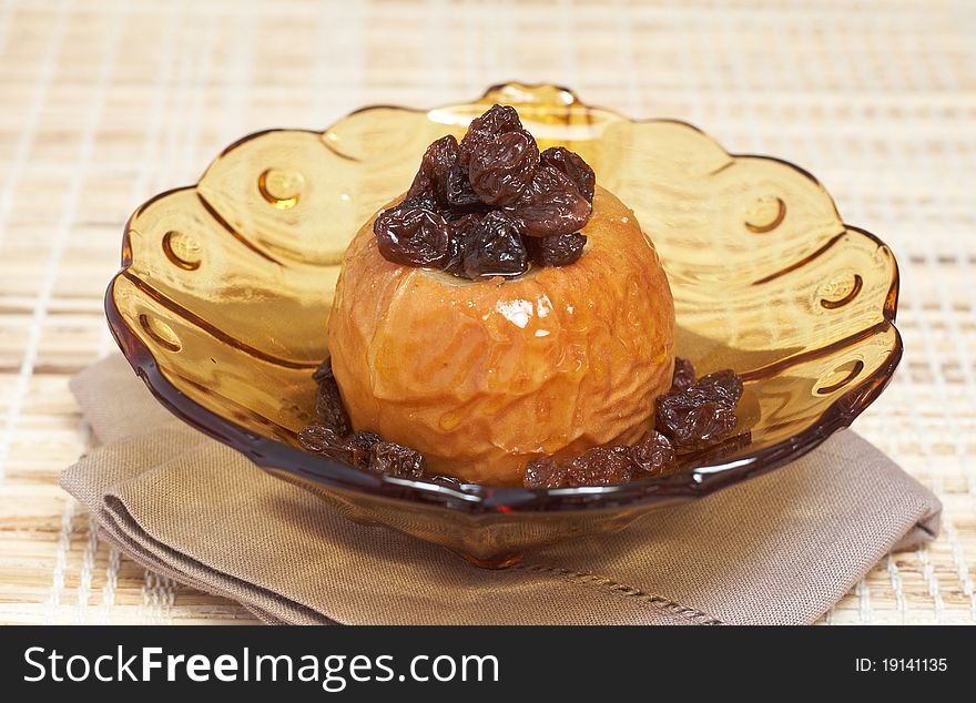 Delicious dessert of freshly baked organic apple with raisins