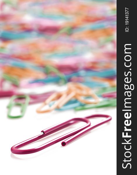 Colorful paper clips on a white background with space for text