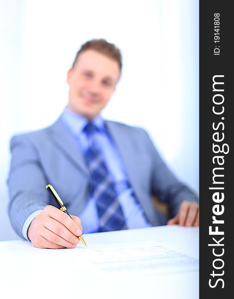 Full length of a handsome business man with hands folded against white background