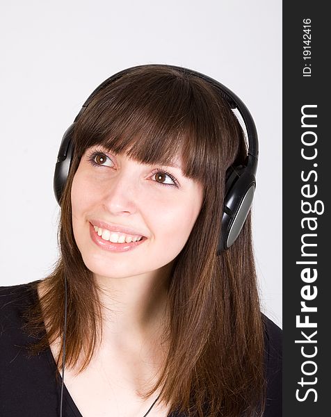 Young pretty woman listening to music in headphones. Young pretty woman listening to music in headphones