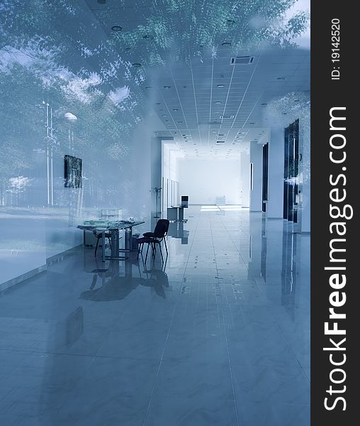 Modern office interior in a bluish tone with reflections of an outter objects. Modern office interior in a bluish tone with reflections of an outter objects