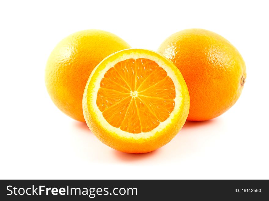 Three vivid oranges isolated on white