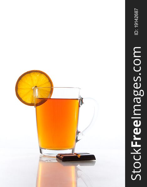 Transparent tea cup with orange slice and chocolate. Transparent tea cup with orange slice and chocolate