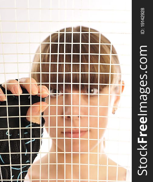 Look through the net of the tennis racket. Look through the net of the tennis racket