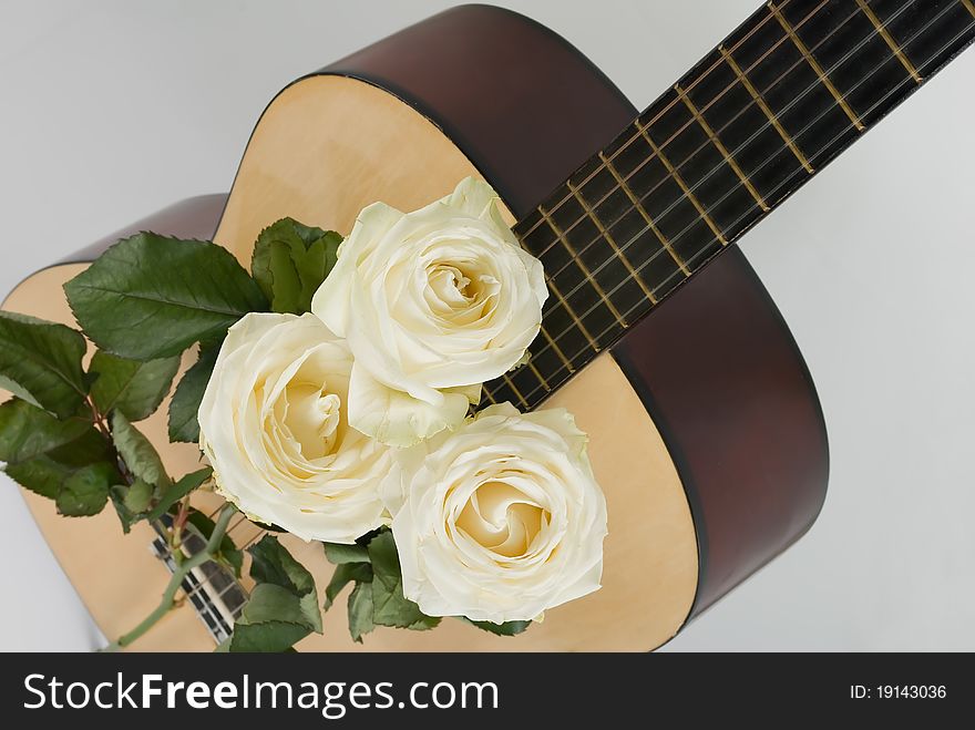 Three white roses and classical guitar. Three white roses and classical guitar