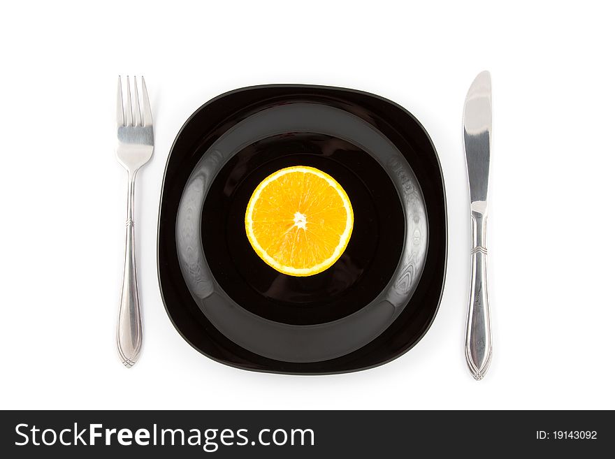 Orange slice served on black plate. Orange slice served on black plate