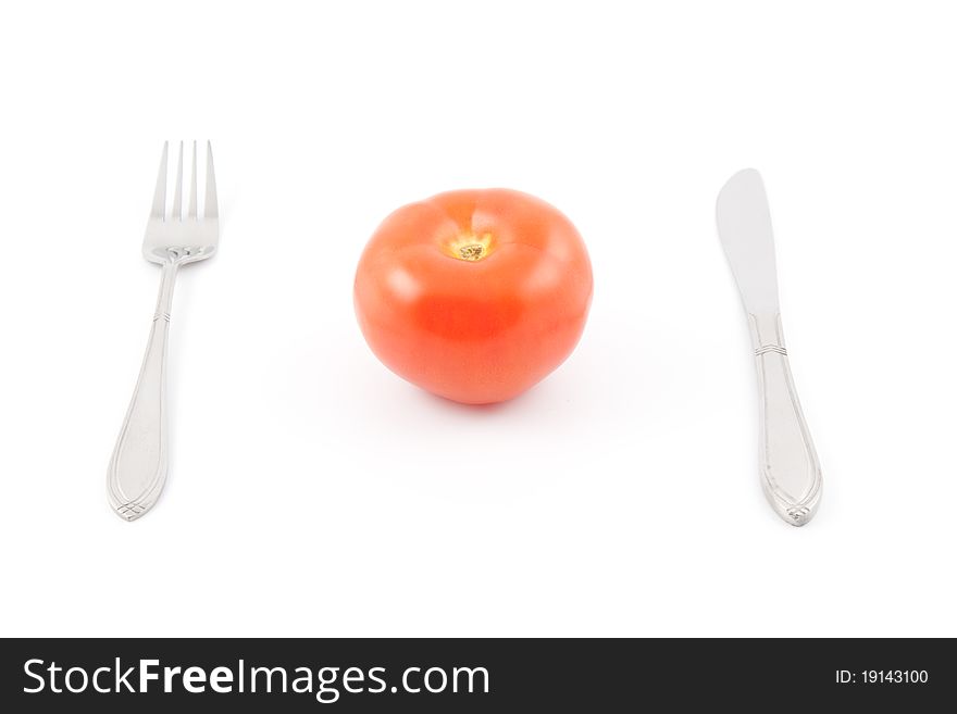 Red tomato with fork and knife