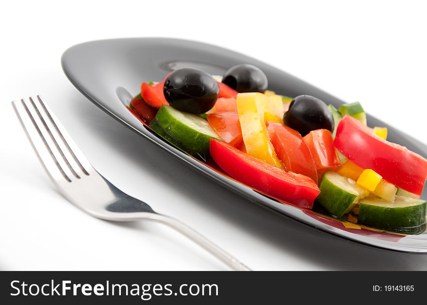 Vivid vegetable salad mixed on a plate