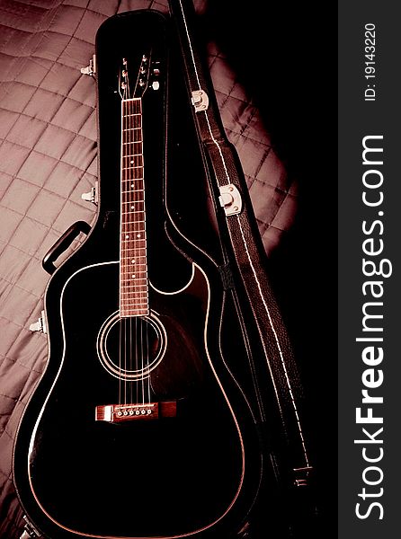 Black shiny acoustic guitar  in case. Black shiny acoustic guitar  in case