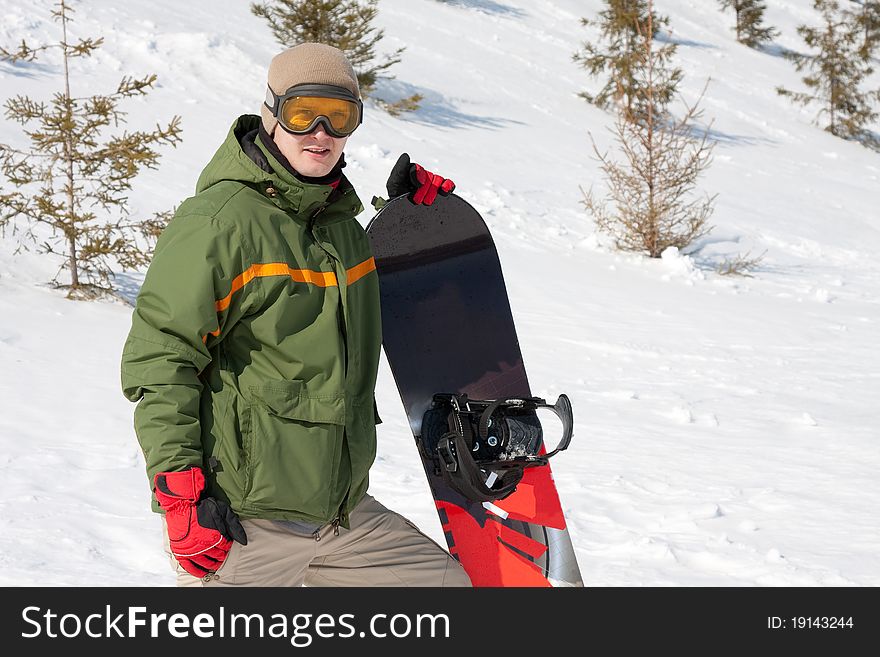 Young man with snowboard outdoors. Young man with snowboard outdoors