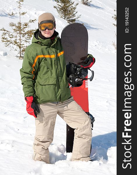 Young man with snowboard on snow