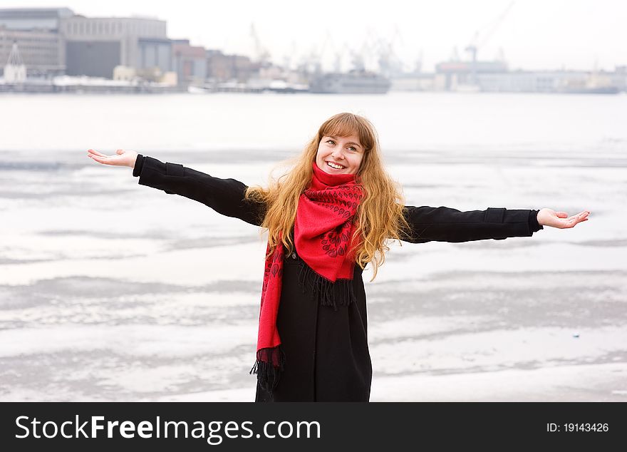 Happy girl with red hair in the red scarf