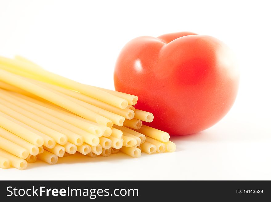 Red tomato and pasta isolated on white