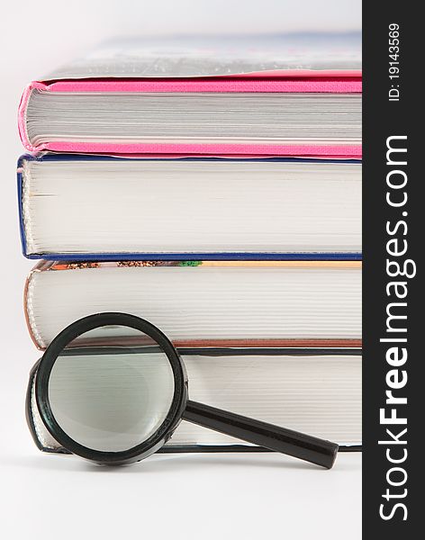 Books And Magnifying Lens