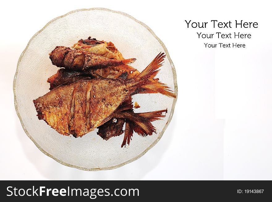A picture of a bowl of fried fish on white background