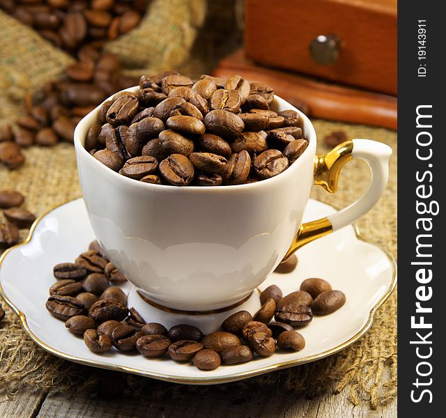 Cup filled with coffee beans