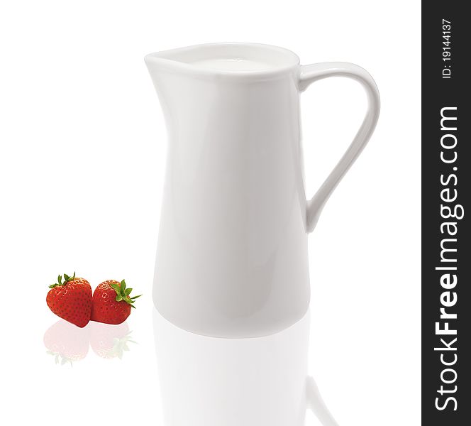 A white clean milk pot with strawberrys. A white clean milk pot with strawberrys