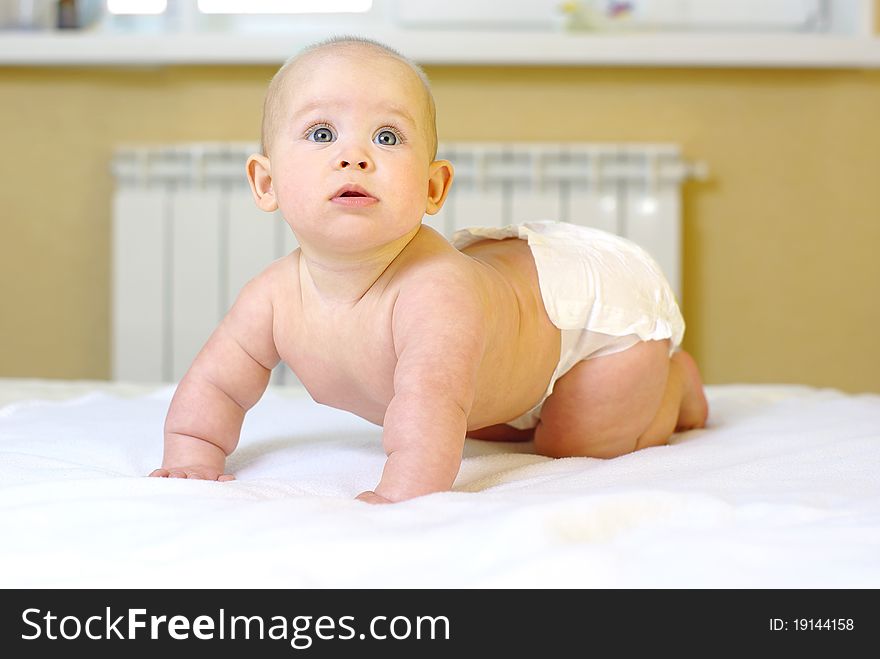 Happy baby girl on bed. Happy baby girl on bed.