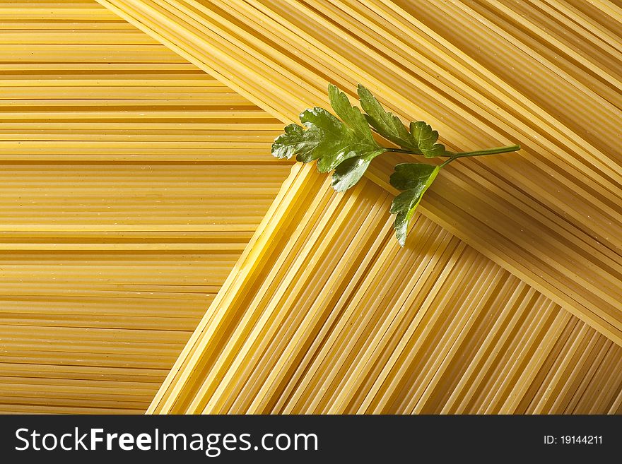 Raw spaghetti in triangle with parsley. Raw spaghetti in triangle with parsley