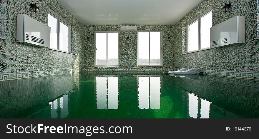 Luxury swimming pool with green water