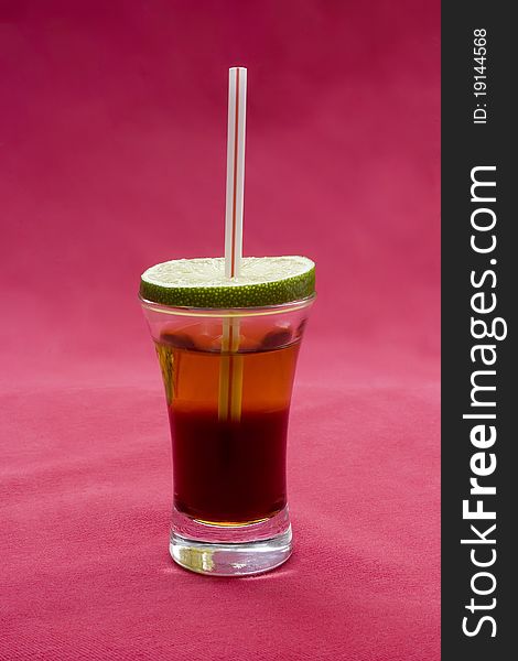 Alcohol cocktail on red background