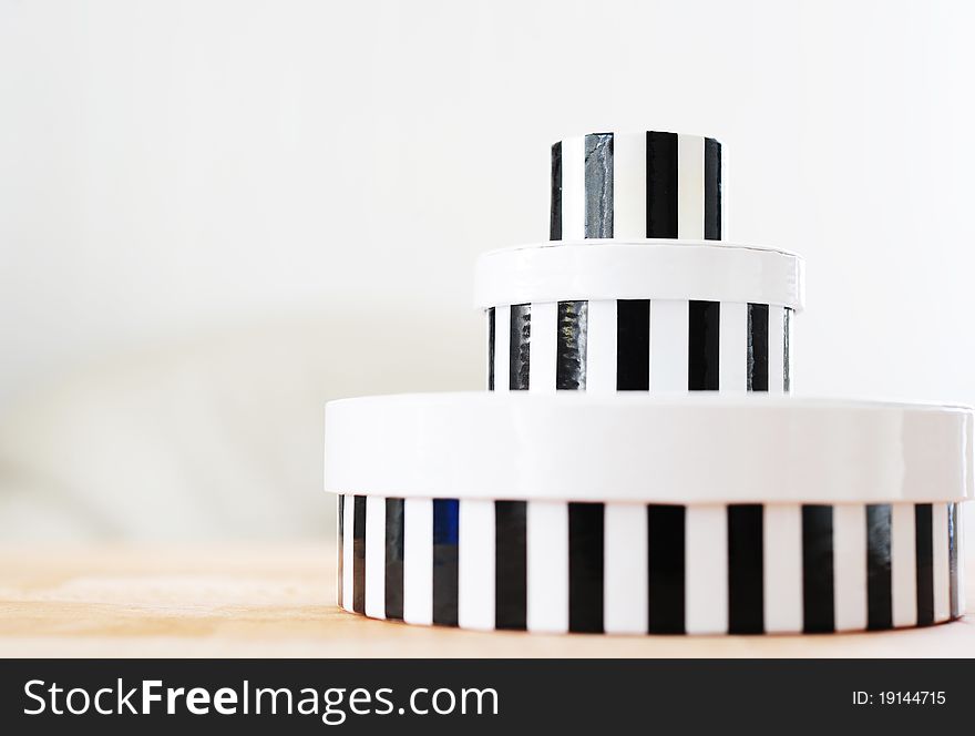 Tower of round boxes in black and white stripes. Tower of round boxes in black and white stripes