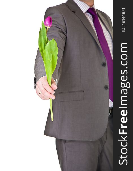 Man in suit and tie holding tulip