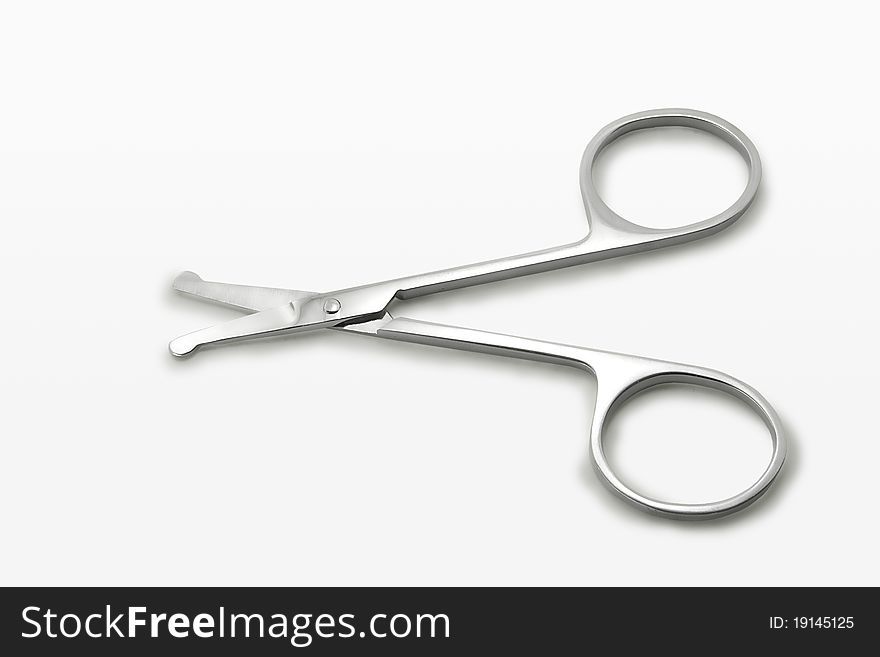 Small scissors on white background