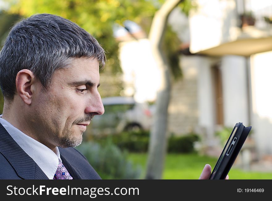 Business Man Working Outdoor with his Tablet, Italy