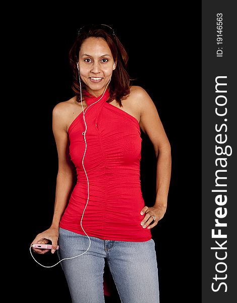 A woman is listening to music with her headphones in.