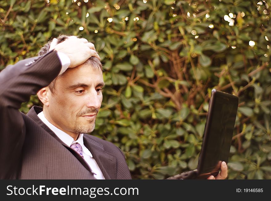 Business Man Outdoor Desperate with his Notebook