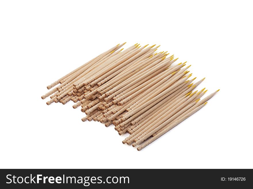 Wooden toothpicks with a yellow edge on a white background. Wooden toothpicks with a yellow edge on a white background