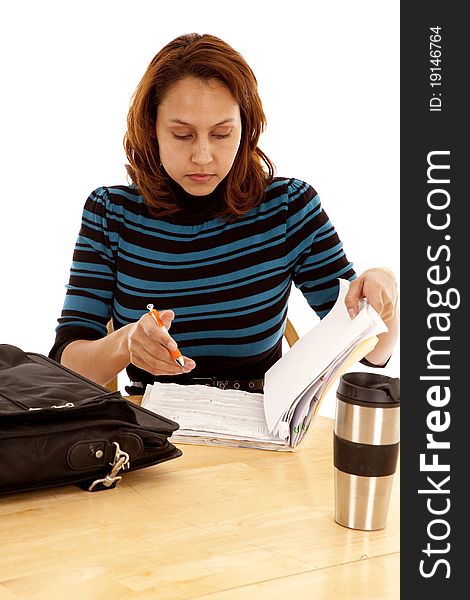 A woman is working at a table with a file folder. A woman is working at a table with a file folder.