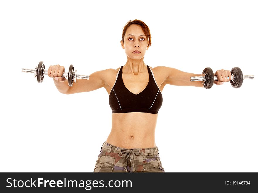 A woman is working out lifting the weights out with her arms. A woman is working out lifting the weights out with her arms.