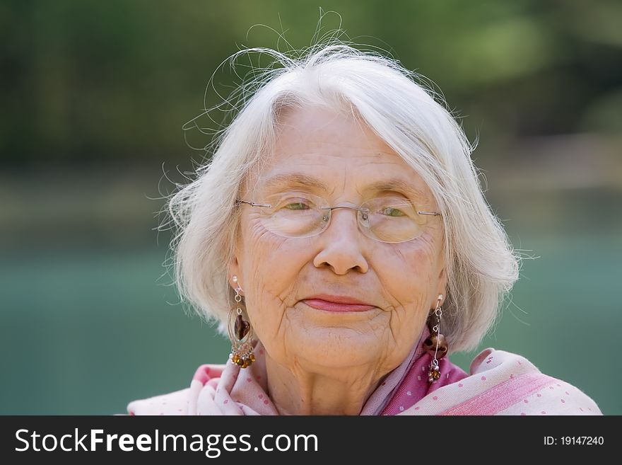 Portrait of elderly woman outside during the day. Portrait of elderly woman outside during the day