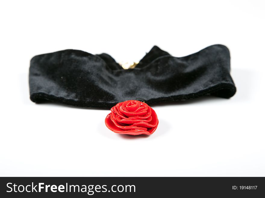 Necklace red rose on black velvet. Hand made from a plastic clay isolated on white background