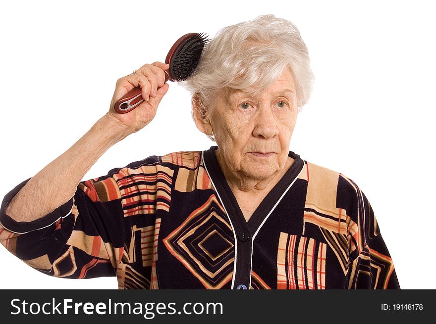 The elderly woman brushes hair on white