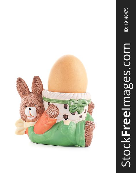 Egg cup easter rabbit with egg on white background