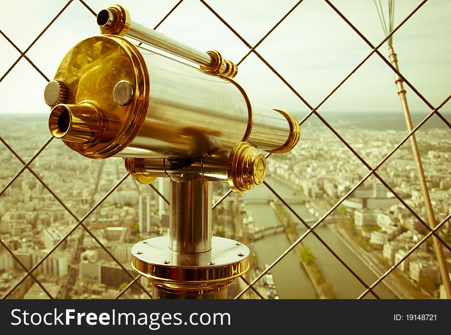 Binocular in Eiffel Tower and view of Paris